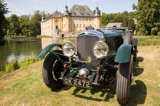 Jüchen, Germany - August 2019. Front view of a rare 1929 Bentley Super Six in a park with a Schloss Dyck castle backdrop. 