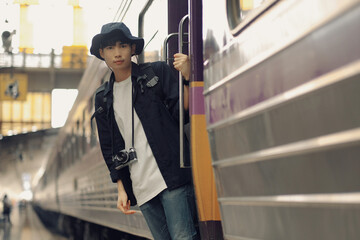 Asian travelers man and camera in train station