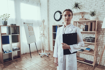 A woman doctor with a note in her hands. 