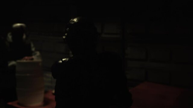 Cyberpunk concept, future world. Police officer halfman bionic cyborg or android is walking through the night area of the city. Science fiction scene, fantasy, sci. World of tomorrow. Neon lighting