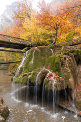 Fototapeta premium Bigar Waterfall in the Romanian mountains - amazing view of one of the most beautiful waterfalls in Europe during an autumn day with great fall colors