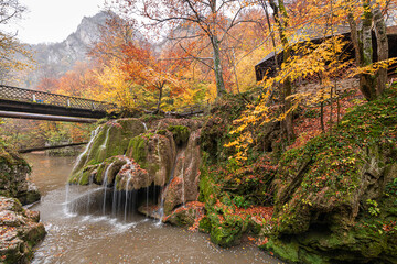 Bigar Waterfall in the Romanian mountains - amazing view of one of the most beautiful waterfalls in Europe during an autumn day with great fall colors