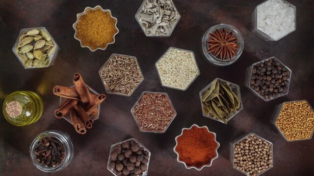 Spices in hexagonal jars on a metal rusty surface. Stop motion animation