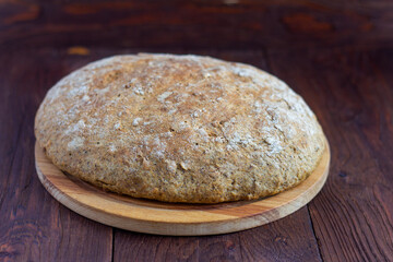 Rustic rye grain bread on the rustic table.Just out of the oven.