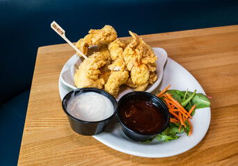 Incredible gluten free breaded chicken tenders. Fried to perfection with delicious gluten free ranch and barbecue sauce on the side. Gluten free stick in the fried chicken to show it's safe for Celiac