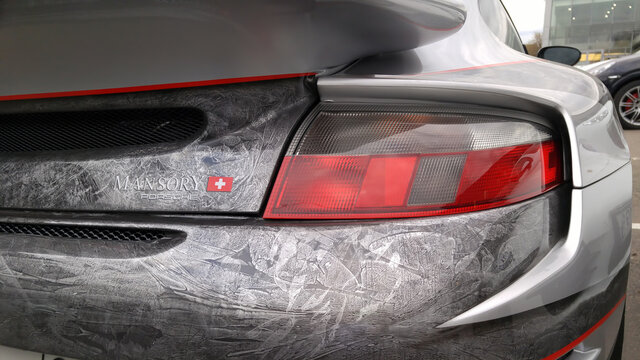 Moscow. Autumn 2018. Gray Porsche 911. Tuned by Mansory. With a wide body kit and vinylography and airbrushing. Exclusive tuning. On parking