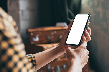 cell phone blank white screen mockup.woman hand holding texting using mobile on desk at coffee shop.background empty space for advertise.work people contact marketing business,technology