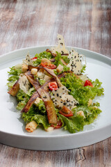 Salad with baked eggplant, mozzarella and romaine lettuce