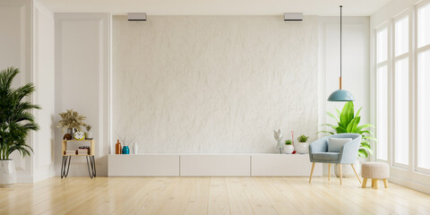 Cabinet for TV on the white plaster wall in living room with armchair,minimal design.