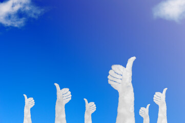 Cloud shape of hands with the raised thumbs on blue sky. Concept success and motivation.