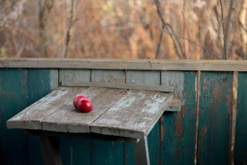Red apples on an old board. Abandoned. Retro vintage background.