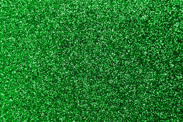 Fototapeta premium Sparkle splash and lens flare on green emerald shiny trendy background. Sequins. Festive background for your projects. Blurred green festive bokeh lights. Christmas festive time concept on background.