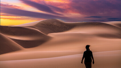 Fototapeta na wymiar woman in landcape with awesome sunset sky over Namib Desert in Namibia, southern Africa