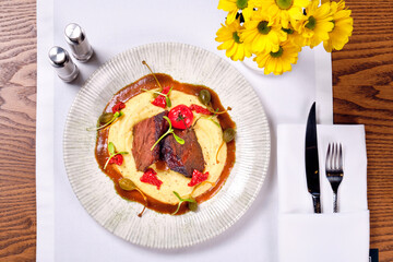 Mashed potatoes and meat. Dish in a plate top view.