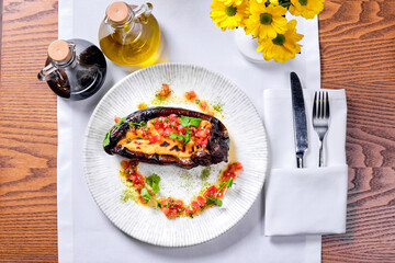 Dish of stuffed zucchini on a table. View from above.