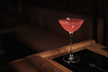 Pink clasic Cosmopolitan vodka cocktail on bar