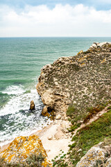 Mountains of steel and stones on the seashore. Wild beach. holidays, privacy, 