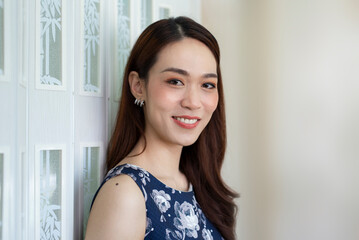 Portrait of beautiful Asian woman smiling brightly looking at the camera