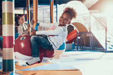 Beautiful girl rides an attraction in the center.