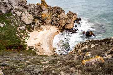 Mountains of steel and stones on the seashore. Wild beach. holidays, privacy, 