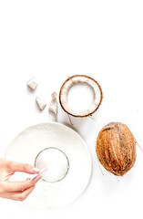 cocktail with coconut on white background top view