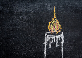 A burning candle drawn on a chalkboard