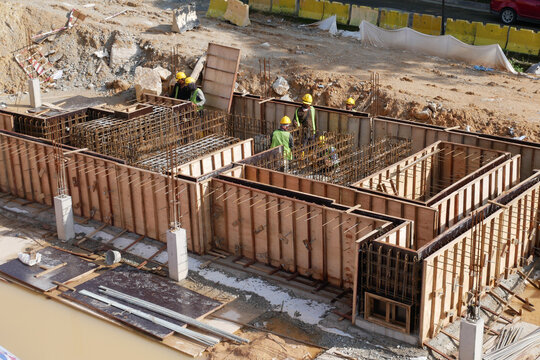 KUALA LUMPUR, MALAYSIA -MARCH 5, 2020: Building ground beam under construction using temporary timber plywood formwork at the site. Reinforced by the reinforcement steel to strengthen the structure. 