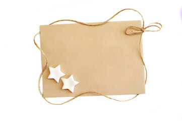 Mock up gift Christmas template greeting card with sheet of kraft paper and rope to the frame on a white background and place for text. Copyspace