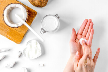 organic cosmetics with coconut on white background top view
