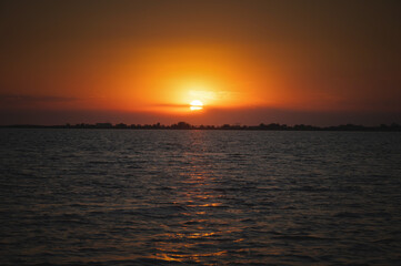 Sunset over the sea lake bay. Low key