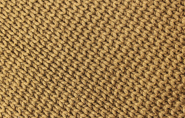 Knitted brown background. Yarn texture. Diagonal knitting