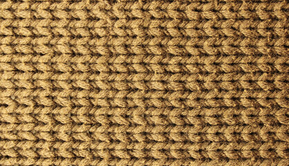 Knitted background. Brown yarn texture. Horizontal knitting