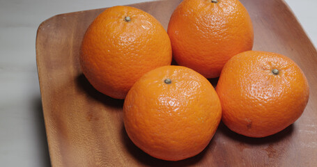 Stack of the citrus fruit on wooden plate