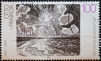GERMANY - CIRCA 1993 : a postage stamp from Germany, showing a painting with sea and sun by the painter Otto Pankok. German painting of the 20th century