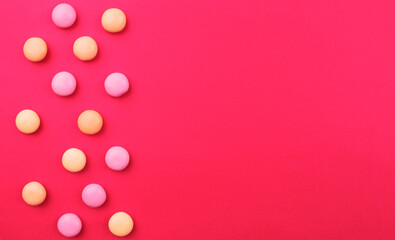 Pink background with round candies for writing