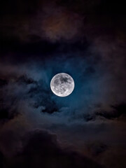 full blue moon on a cloudy night © Michelle Holton