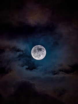 full blue moon on a cloudy night