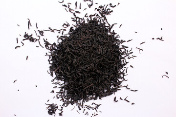 Handful of dried black tea on white background