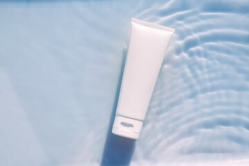 Cosmetic moisturizer cream , micellar toner, or emulsion with granules. abstract beauty background. Reflections of scattered sun texture.