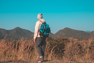 Soft focus blur Asian young men 25-30 year selfie standing Turn around hiking joy with mountain blue sky landscape nature hiking outdoor at reservoir MEATIP Lamphun Thailand