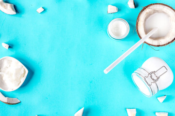 concept organic cosmetics with coconut on blue background top view