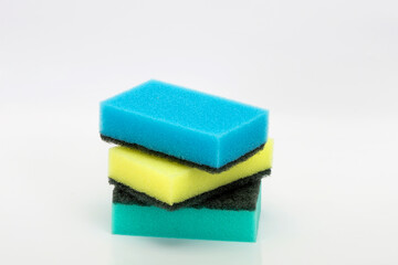 Colored washcloths for the kitchen. Cleaning of the apartment. Cleaning sponges on a white background. Sponges for washing dishes, household goods.