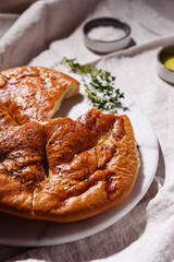 Homemade fresh baked Fougasse (French Bread) with thyme and olive oil on white background. Traditional Provencal dishes. Selective focus