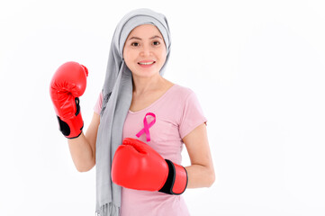 Muslim religious women in hijab put a pink ribbon on their tops. And wearing boxing gloves on a...