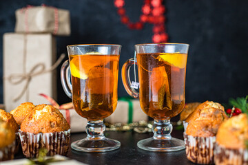 christmas sweet dessert muffins cupcakes and cup of tea party festive table setting holidays new year gift tasty top view copy space food background rustic