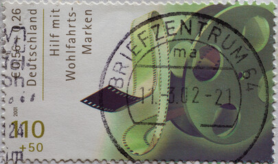 GERMANY - CIRCA 2001 : a postage stamp from Germany, showing a green roll of film on a charity donation postal stamp