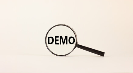 Magnifying glass with word demo on beautiful white background. Business concept, copy space.