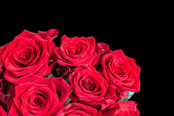 Red roses isolated on black background. Romantic bouquet of flowers.