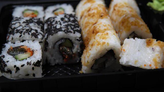 Sushi roll set with smoked eel and caviar, selective focus.