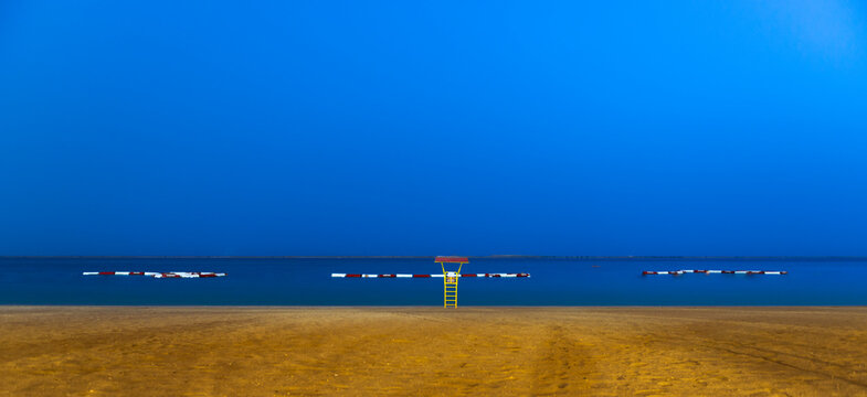 At the beach, Abu Dhabi closed to al Bateen, a yellow life guard house during the blue hour with enough copy space, no people and a blue horizon